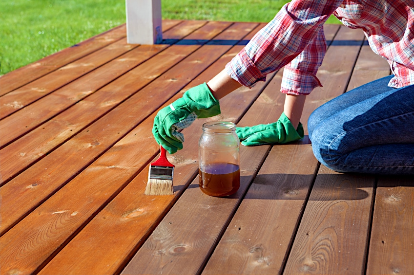 Applying Stain to Deck with Brush